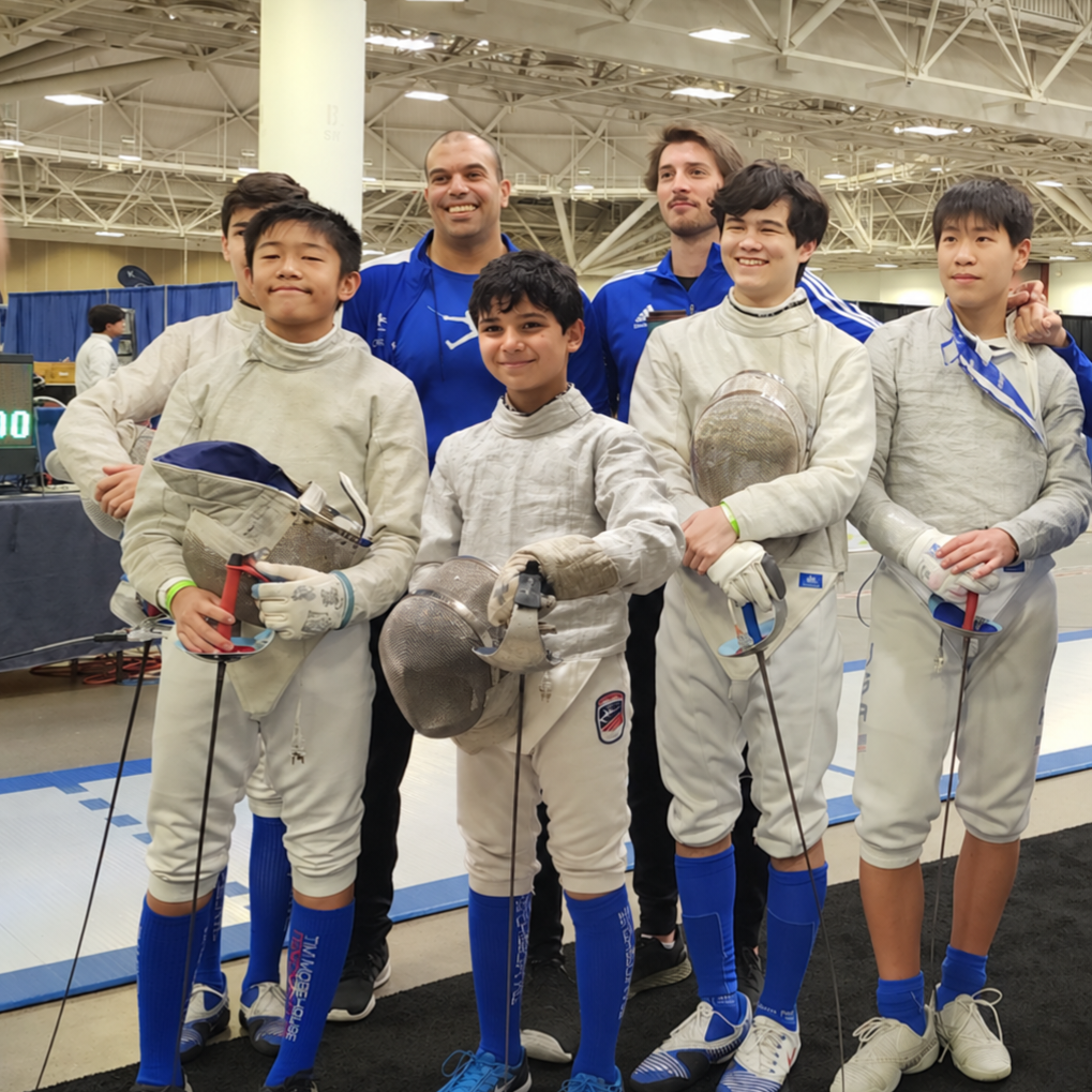 Eli Dershwitz and Ahmed Hamdy Refaee with Benjamin Gurewich and fellow fencers