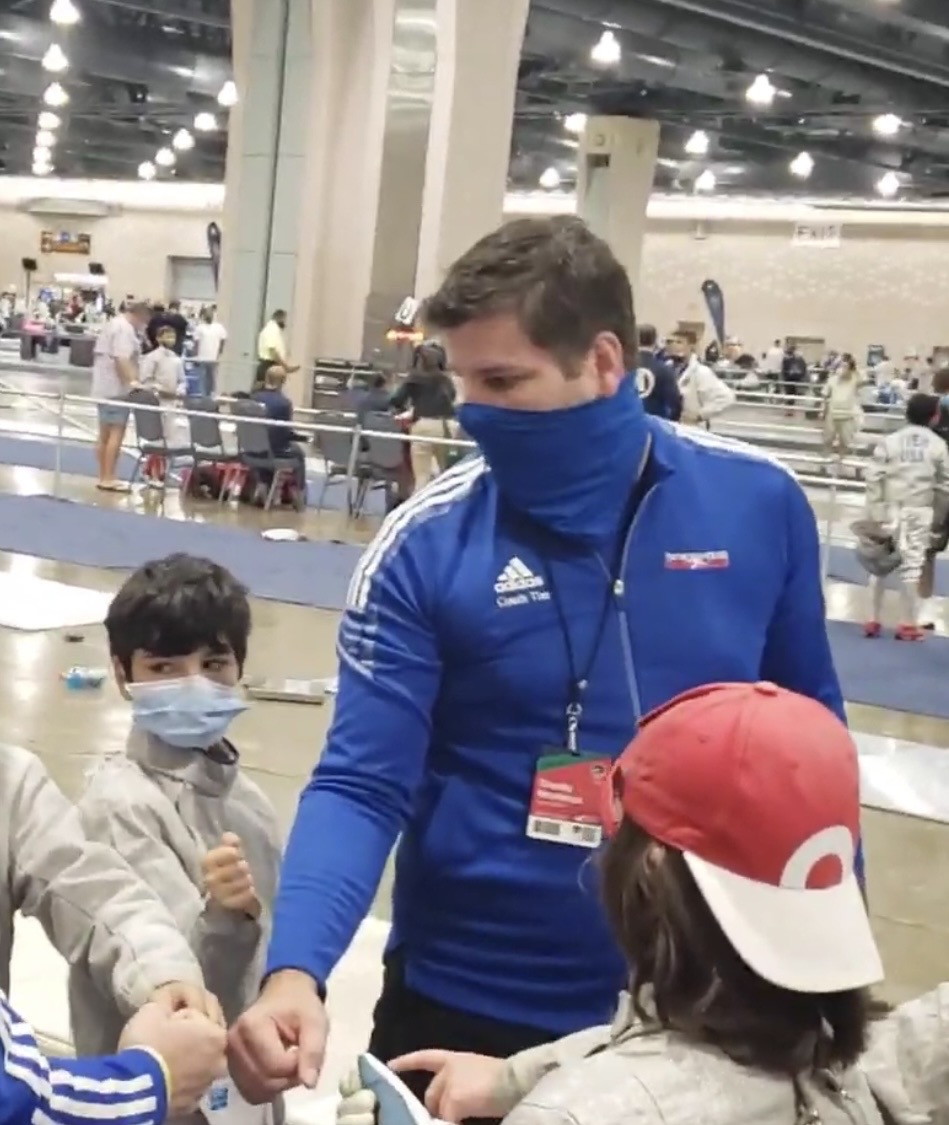 Tim Morehouse coaching Benjamin Gurewich and young fencers during a competition