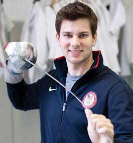 Tim Morehouse holding a sabre and fencing mask
