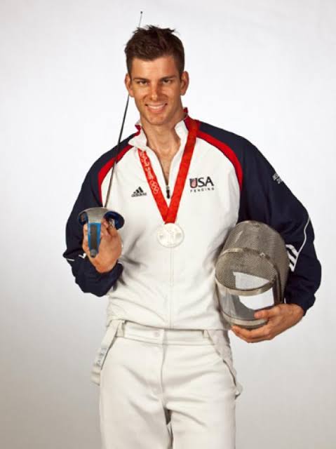 Tim Morehouse with his Olympic silver medal and fencing mask