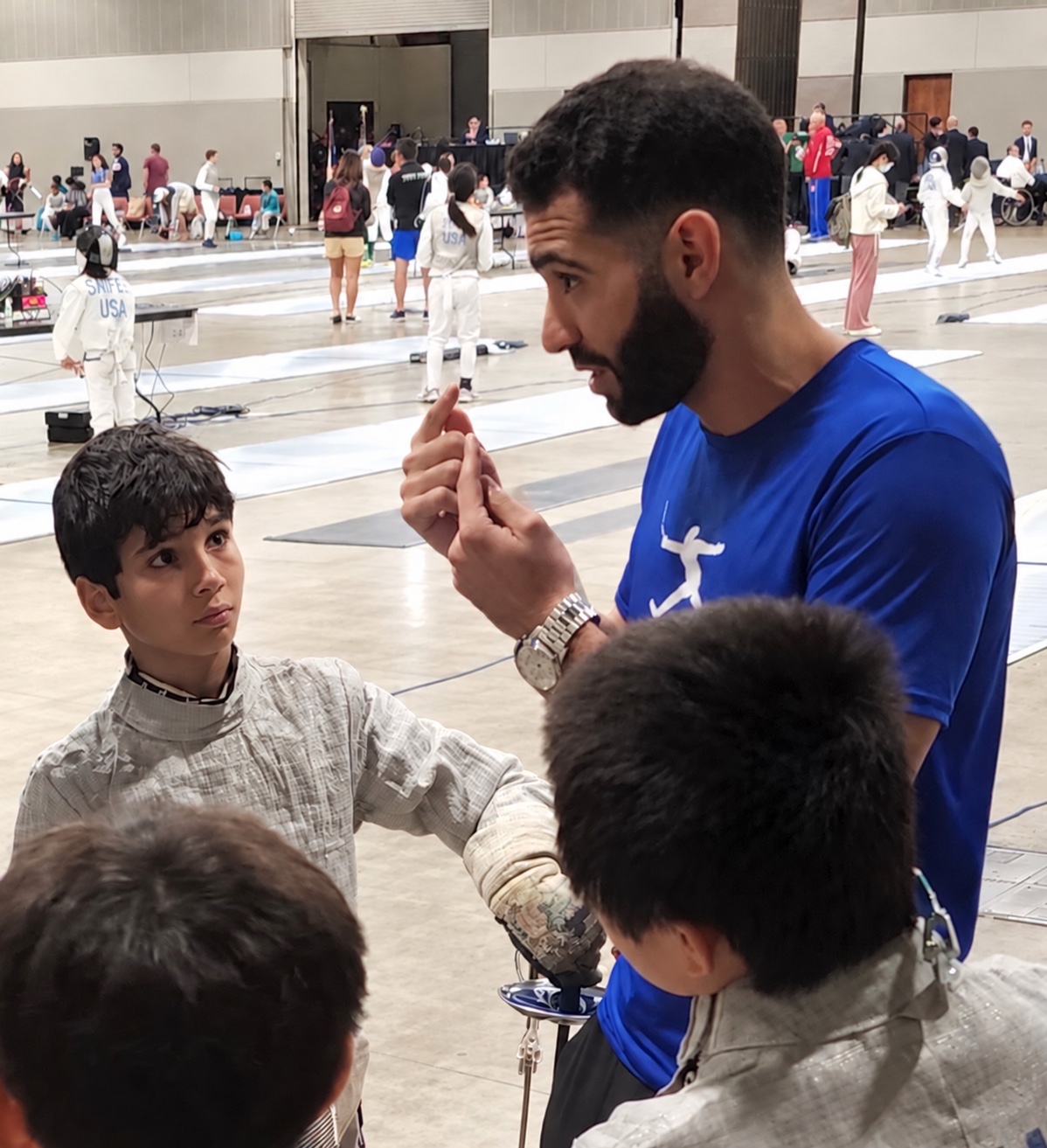 Ziad Elsissy coaching Benjamin Gurewich during a fencing competition