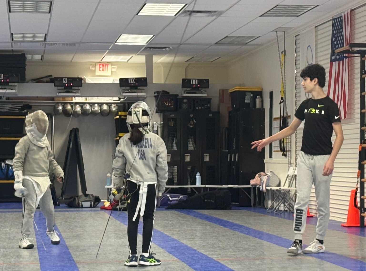 Benjamin Gurewich giving instructions to young sabre fencers on the piste